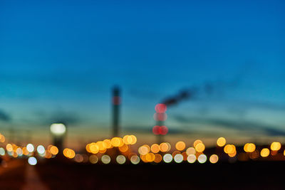 Defocused image of illuminated lights in city at night