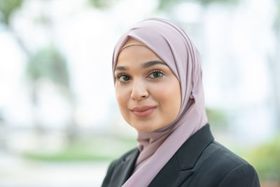 Portrait of smiling young woman in headscarf