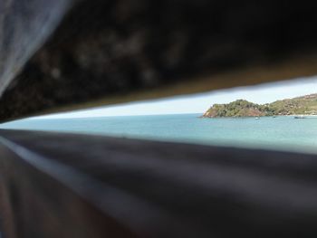 Close-up of rocks by sea against sky