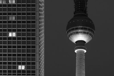 Low angle view of communications tower at night