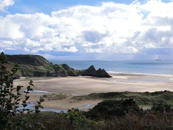 View of beach against cloudy sky