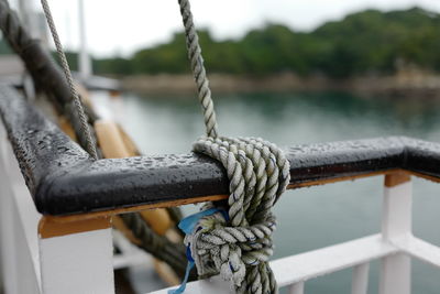 Close-up of rope tied on railing