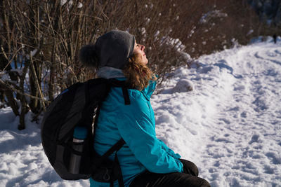 Rear view of woman on snowy field during winter