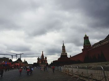 Group of people in front of building against sky