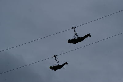 Low angle view of overhead cable against sky