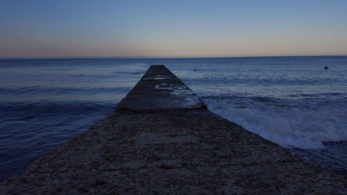 Scenic view of sea against clear sky during sunset