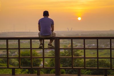 Silhouette of man in sea at sunset