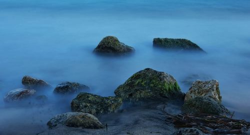 Scenic view of sea against rocks