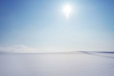 Scenic view of snow covered landscape against sky