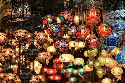 Illuminated colorful lanterns hanging at antique shop