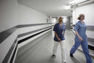 Female doctors walking through hospital corridor