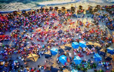 High angle view of people at beach during sunset