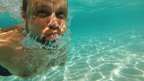 Close-up of man swimming undersea