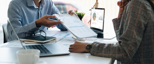 Midsection of business colleagues working in office