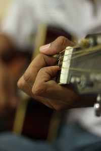 Midsection of person playing guitar