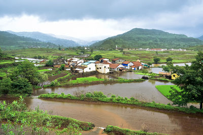 Scenic view of buildings and mountains against sky