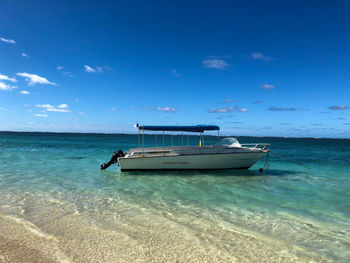 Scenic view of sea against blue sky