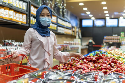 Woman standing at market stall