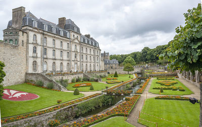 Buildings in garden against sky