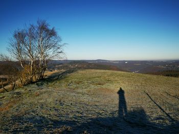 Scenic view of field against clear blue sky