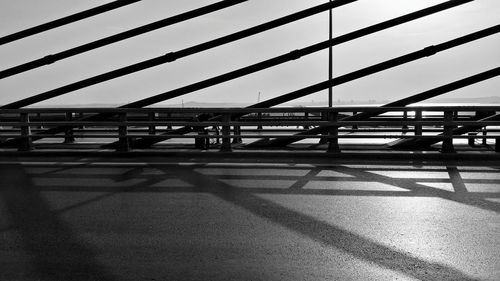 Bridge over road against sky in city