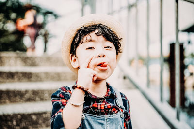 Close-up portrait of boy sticking out tongue