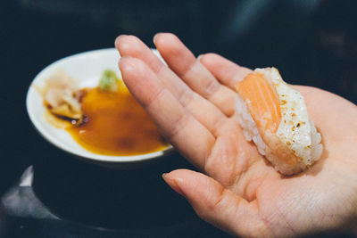 Cropped image of hand holding food