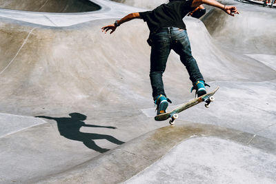 Low section of man skateboarding