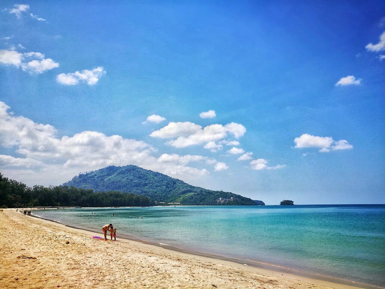 sky, water, beach, cloud - sky, sand, sea, nature, blue, vacations, travel destinations, mountain, outdoors, scenics, mountain range, tourism, day, real people, beauty in nature, coastline, tranquility, leisure activity, adults only, one person, one woman only, people, tranquil scene, adult, only women