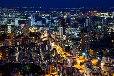 High angle view of illuminated city buildings at night