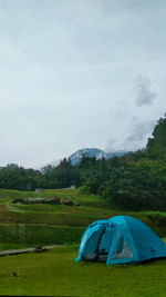 Tent on field against sky