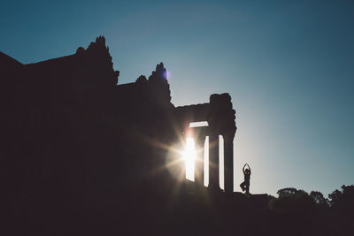 Silhouette angkor wat against sky