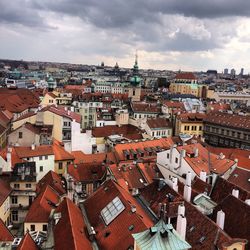 Cityscape against cloudy sky