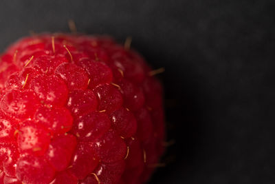 Close-up of strawberry over black background