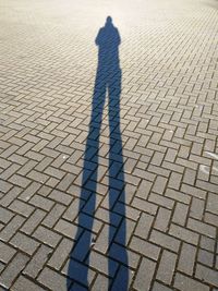 Shadow of man on tiled floor