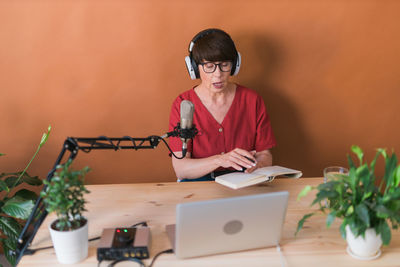 Senior woman podcasting in studio