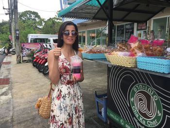 Portrait of woman standing by concession stand