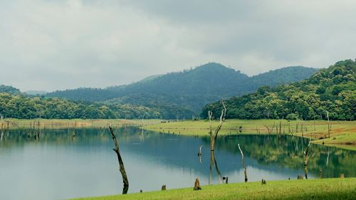 Scenic shot of calm countryside lake against mountain range