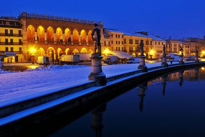 Reflection of illuminated buildings in canal