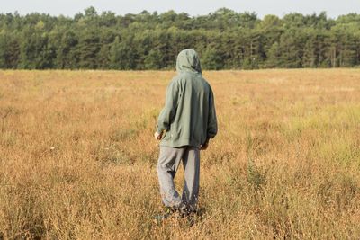 Rear view of man standing on field