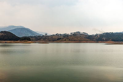 Lake calm water with mountain background at day from flat angle