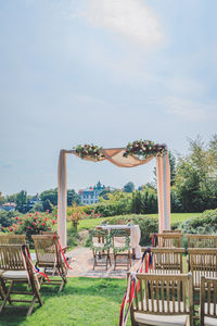 Chairs arranged at park during wedding ceremony