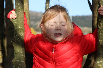 Portrait of a girl with red eyes closed