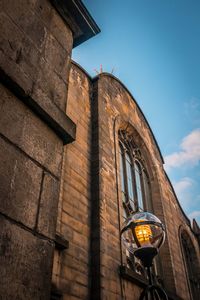 Low angle view of illuminated building against sky