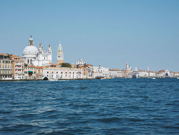 View of buildings in city against clear sky