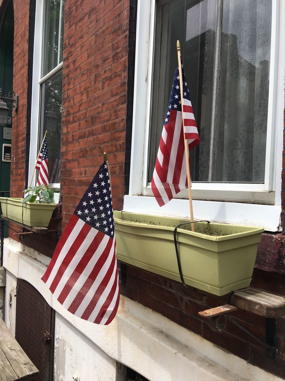 CLOSE-UP OF FLAGS AGAINST BUILDING