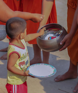 Midsection of women standing in bowl