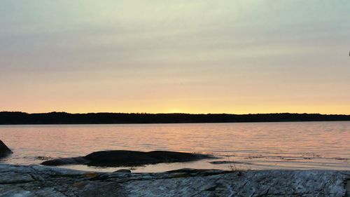 Scenic view of lake against sky during sunset