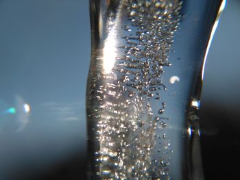 Close-up of water drops on illuminated city at night