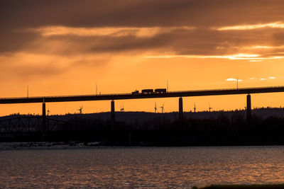 Truck crossing the bridge at sunset